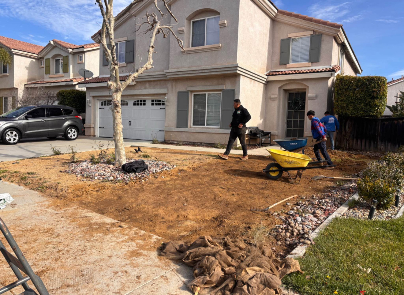 Front yard stripped to dirt with old sod removed