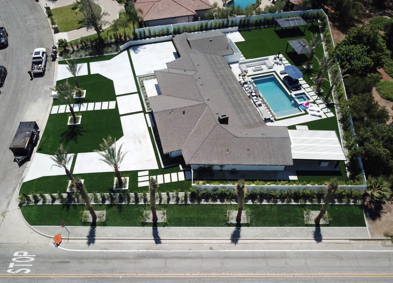 Overhead drone view of the finished estate with pool, turf lawns, gazebos and concrete flatwork